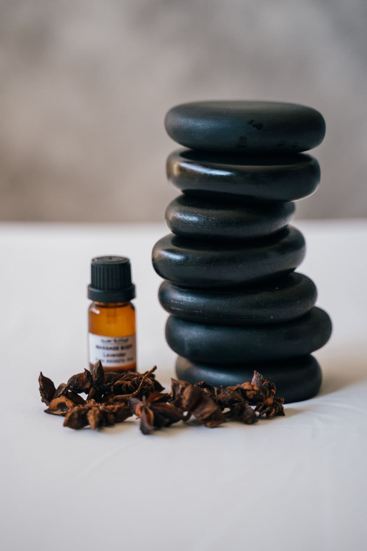 Massage oil and heated basalt stones